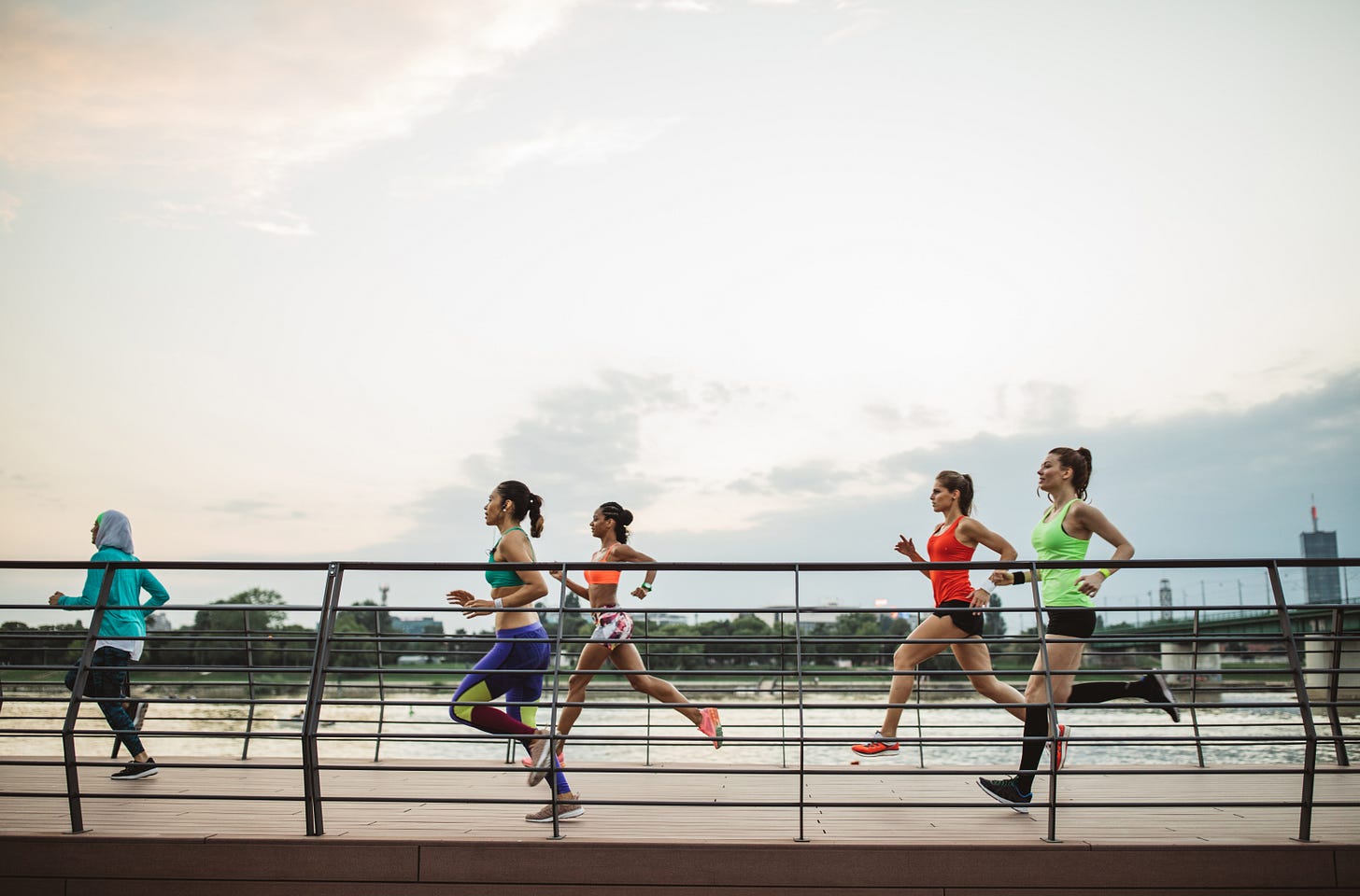 Group of runners on a bridge.