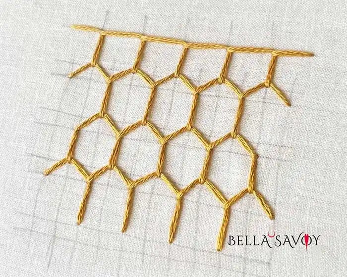 Gorgeous Honeycomb Stitch Tutorial 71 golden honeycomb stitch on white fabric with guidelines