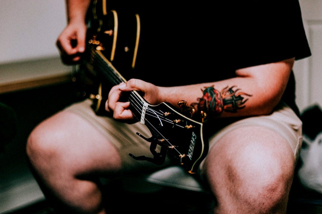 man playing acoustic guitar