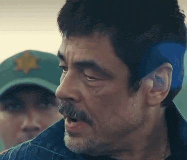 a close up of a man 's face with a star on his hat