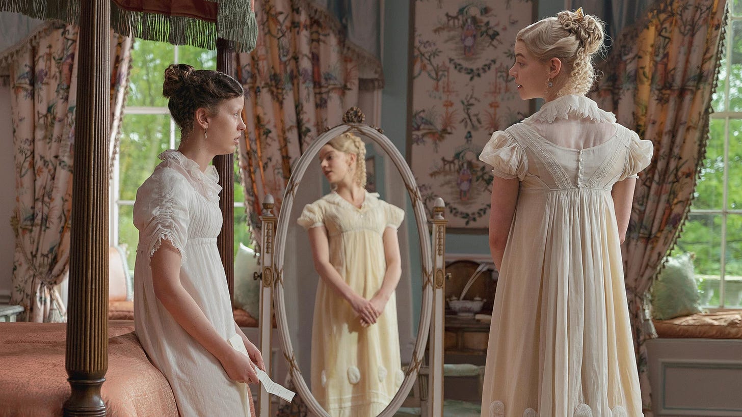 Harriet is holding a letter that Robert Martin has written her as Emma admires herself in the mirror. 