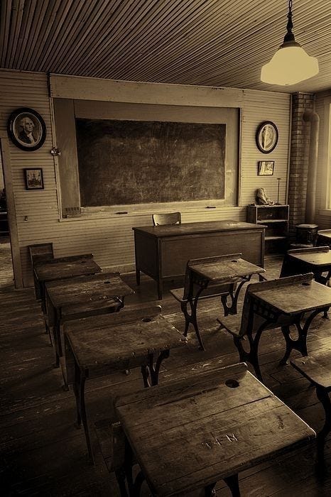 This may contain: an old school room with desks and chalkboard
