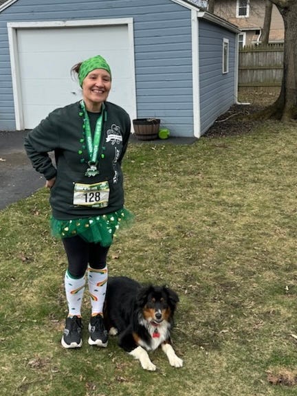 Me dressed in a truly awful St. Patrick's Day themed running outfit for a local race with my black, brown, and white dog Harry by my side. Harry is not judging my terrible outfit, though one could hardly blame him if he did.