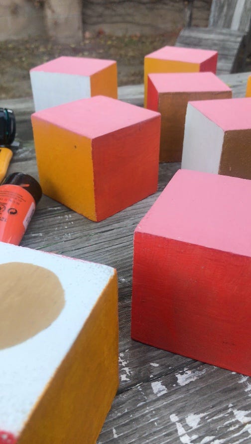 Wooden cubes painted with acrylics in a variety of colors