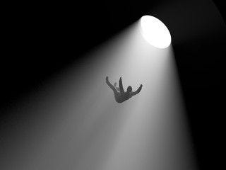 This may contain: a person falling off the side of a cliff under a bright light in black and white