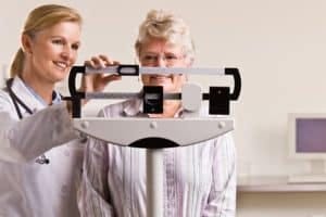woman on doctor's office scale