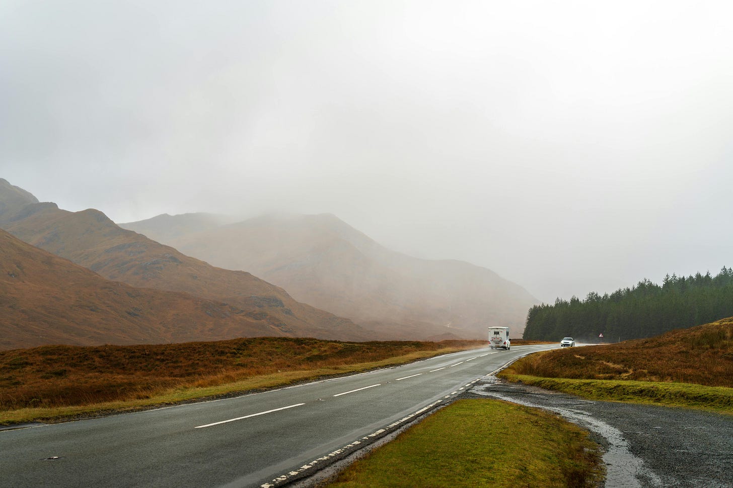 Photograph of Scenic Mountain Road with Misty Landscape by Michał Robak