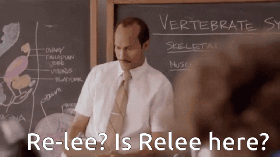 Animated GIF of a substitute teacher in a short-sleeved shirt and tie standing in front of a chalkboard headed "Vertebrate Systems". He reads from a sheet and frowns as he asks, in the caption, "Re-lee? Is Relee here?"