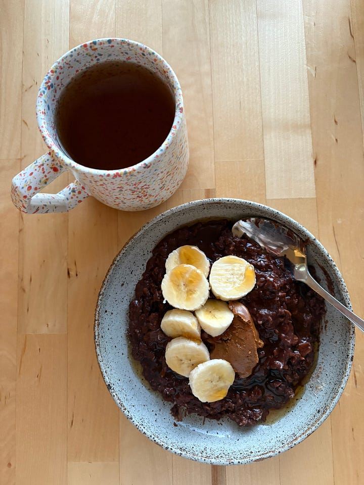 Bowl of porridge with banana, walnuts, honey and butter. A second bowl of coca porridge with banana, maple syrup and almond butter. A peppermint tea nearby.