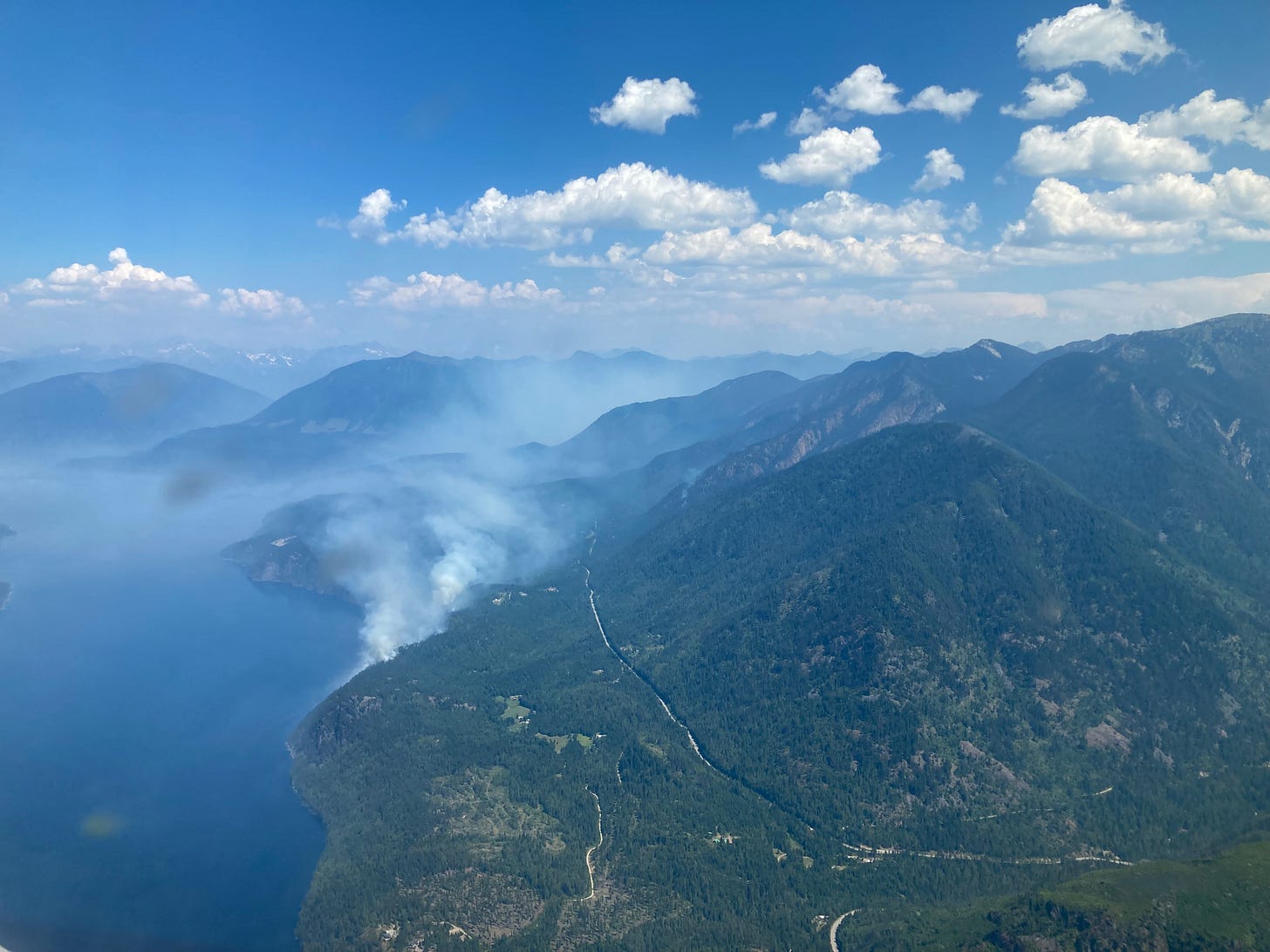 al aerial view of the aylwin creek wildfire, showing the fire burning on the slopes of a mountain by slocan lake. al aerial view of the aylwin creek wildfire, showing the fire burning on the slopes of a mountain by slocan lake.