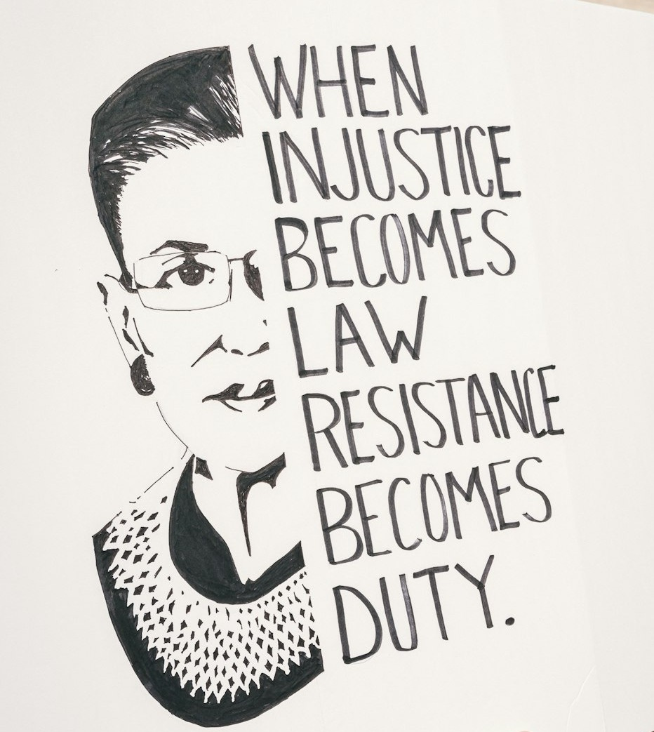 a person holding a sign that says when justice becomes law, resistance becomes duty a person holding a sign that says when justice becomes law, resistance becomes duty