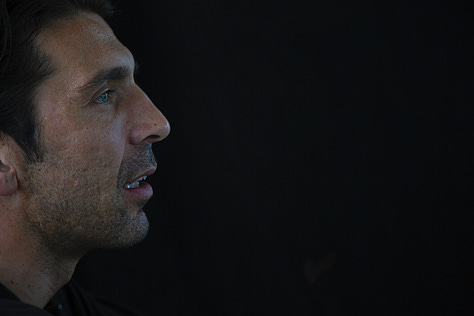 Gianluigi Buffon during a filmed interview on May 12, 2012: shown smiling, speaking, in profile, gesturing with emphasis, and seated against a black background.