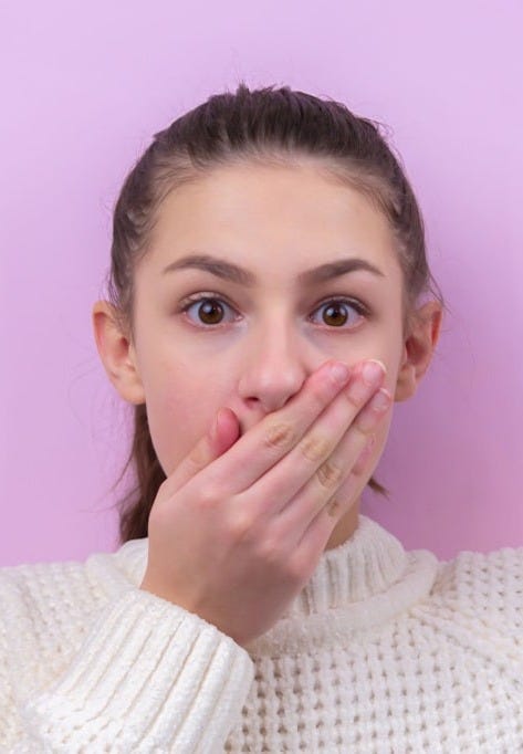 woman in white sweater holding blue balloon