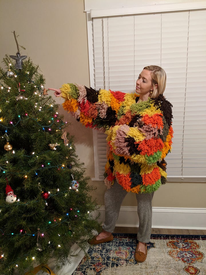 Author and author friend in costume at an outdoor party. Plus, author wearing yarn coat by a Christmas tree.