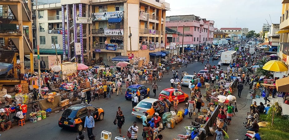 A street with several buildings and many people