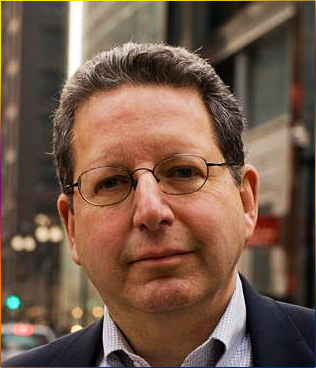 Headshot of Michael Antman wearing suit with spectacles in urban setting