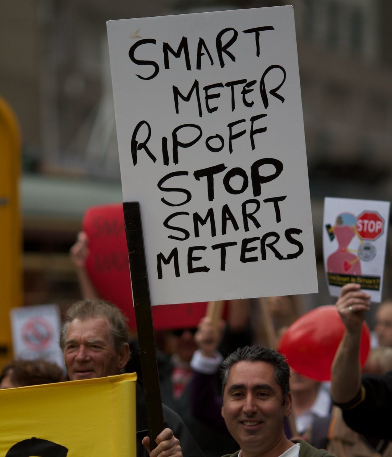 Smart meter ripoff, stop smart meters sign at protest Smart meter ripoff, stop smart meters sign at protest