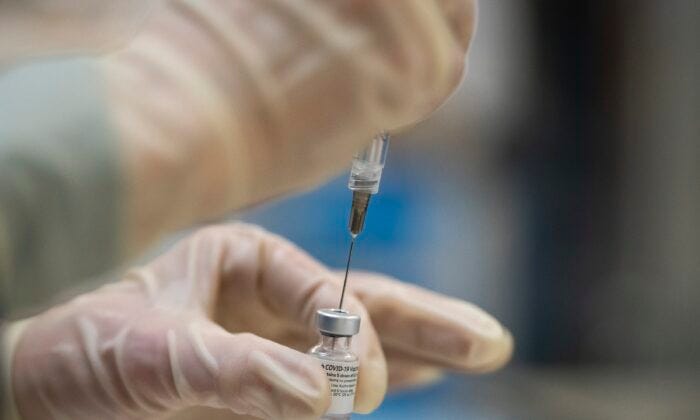 A healthcare worker prepares Pfizer COVID-19 vaccine doses in Portland, Ore., in a file photograph. (Nathan Howard/Getty Images)