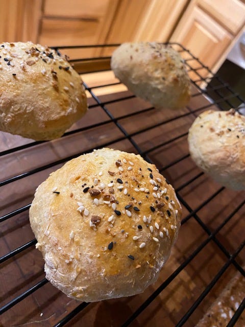 four seasoned rolls on a wire rack