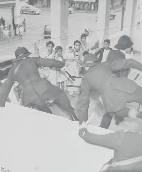 South African police protect South African-Indians from a mob during the Durban Race Riots of January 1949, a period of violence against the Indian community.
