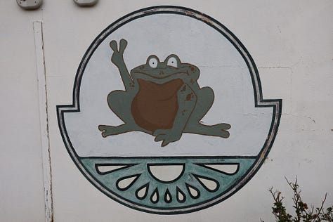 People drinking beer sitting down and standing up with frogs and toads in the background