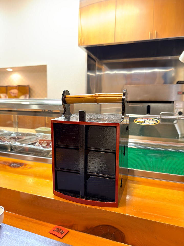 Three box set which included a sperm sac appetizer, a three tiered sushi bento and an extra grilled scallop