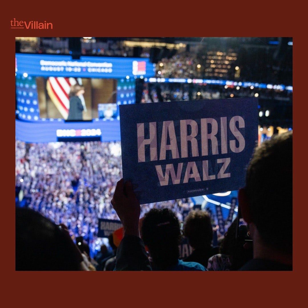 Audience members hold Harris Walz signs as Kamala Harris takes the stage at the DNC.