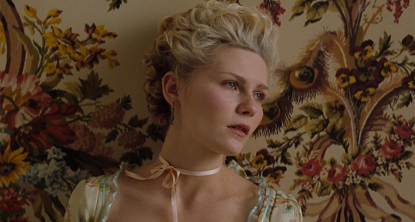 Marie Antoinette | Still features Kirsten Dunst as the titular queen against a floral wallpaper.