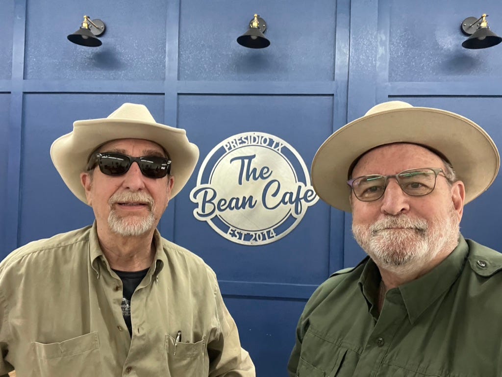 Two men wearing hats and sunglasses

Description automatically generated