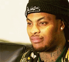 a close up of a man wearing a beanie that says ' hugs ' on it a close up of a man wearing a beanie that says ' hugs ' on it