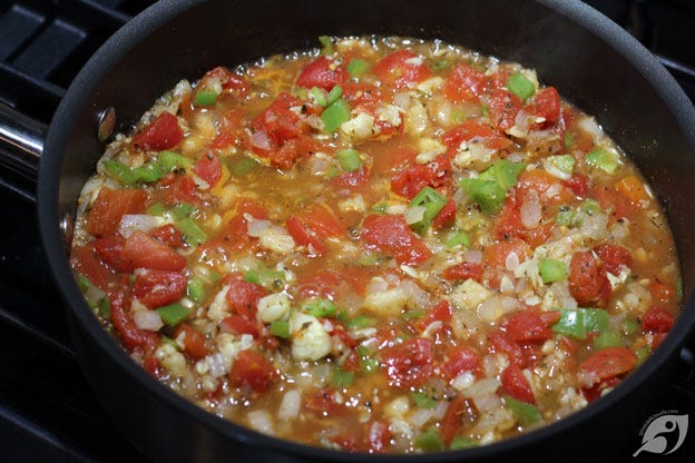 Mixed vegetables and tomatoes in the skillet to simmer Mixed vegetables and tomatoes in the skillet to simmer