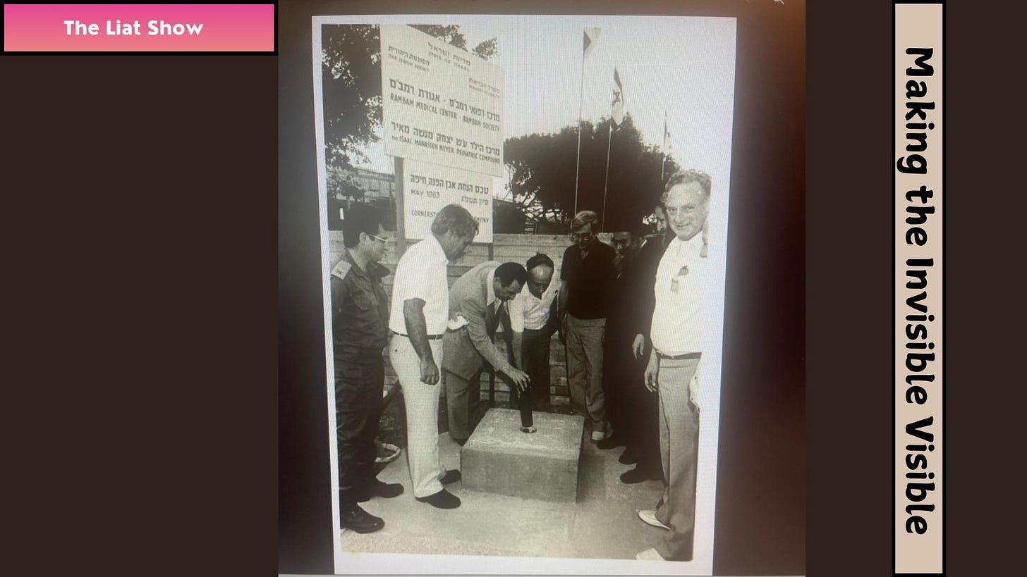 Liat Portal for The Liat Show: Rambam Children’s Hospital Cornerstone, 1983 Liat Portal for The Liat Show shows a historical black and white photograph from the laying of the cornerstone for the construction of the Children’s Hospital at Rambam Medical Center in Haifa in 1983. Several people stand around the cornerstone during the ceremony, with a Rambam Medical Center sign visible behind them. Henry Portal is not pictured, but he prepared and wrote the scroll placed inside the pipe for the cornerstone. The scroll is now preserved in the Rambam museum. family memory, Rambam history, cornerstone ceremony, Henry Portal’s scroll, public legacy. Liat Portal for The Liat Show: Rambam Children’s Hospital Cornerstone, 1983 Liat Portal for The Liat Show shows a historical black and white photograph from the laying of the cornerstone for the construction of the Children’s Hospital at Rambam Medical Center in Haifa in 1983. Several people stand around the cornerstone during the ceremony, with a Rambam Medical Center sign visible behind them. Henry Portal is not pictured, but he prepared and wrote the scroll placed inside the pipe for the cornerstone. The scroll is now preserved in the Rambam museum. family memory, Rambam history, cornerstone ceremony, Henry Portal’s scroll, public legacy.