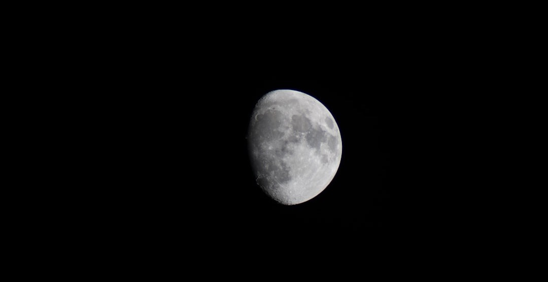 The moon is seen in the dark sky