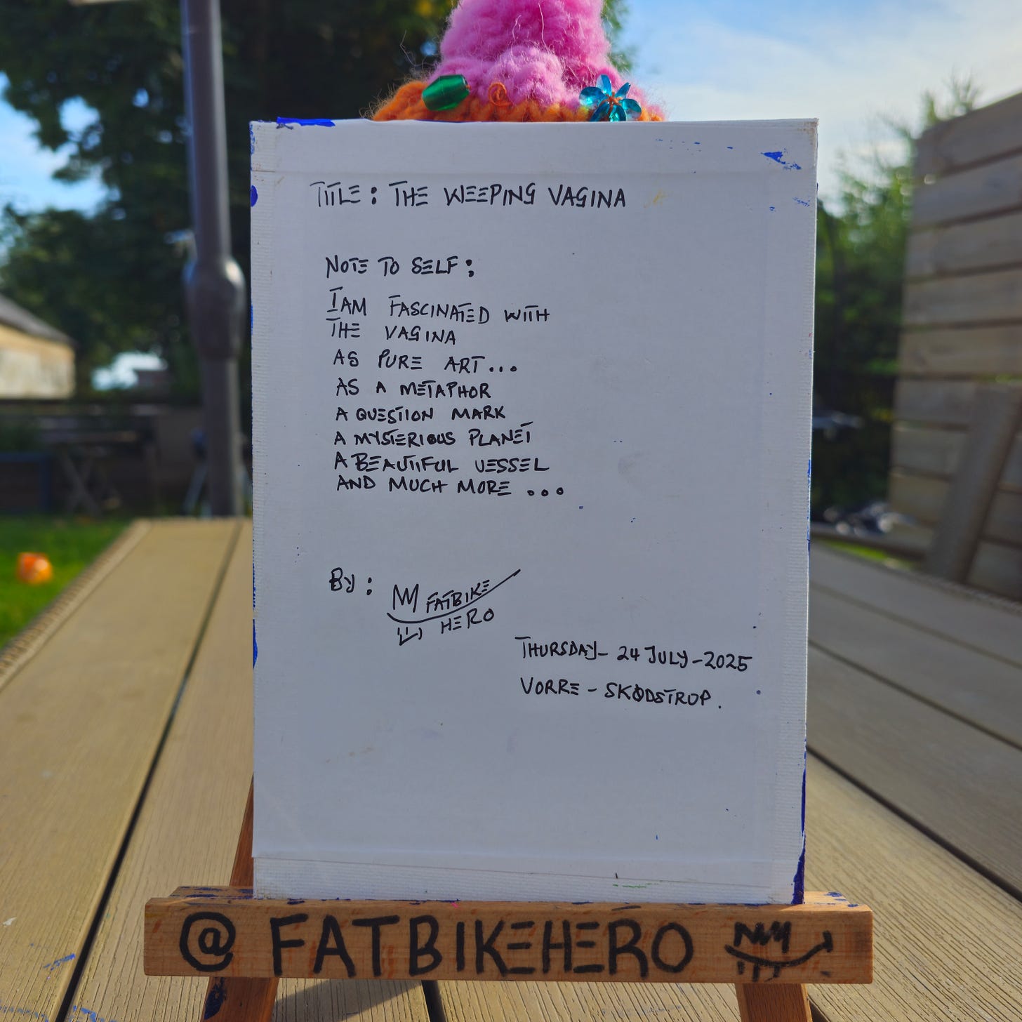 Alt Text: The back of a canvas showing a handwritten inscription in black marker. The text reads "TITLE: THE WEEPING VAGINA" followed by a poetic "NOTE TO SELF" describing the fascination with the subject as a metaphor and vessel. It is signed "By: FATBIKE HERO," dated "Thursday - 24 July - 2025," and located "VORRE - SKØDSTRUP." Alt Text: The back of a canvas showing a handwritten inscription in black marker. The text reads "TITLE: THE WEEPING VAGINA" followed by a poetic "NOTE TO SELF" describing the fascination with the subject as a metaphor and vessel. It is signed "By: FATBIKE HERO," dated "Thursday - 24 July - 2025," and located "VORRE - SKØDSTRUP."