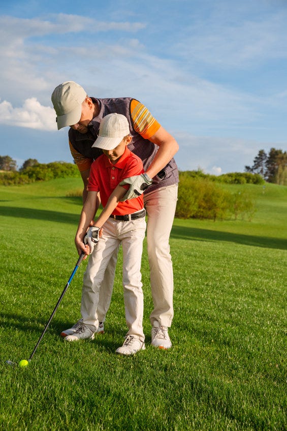 Father and son playing golf
