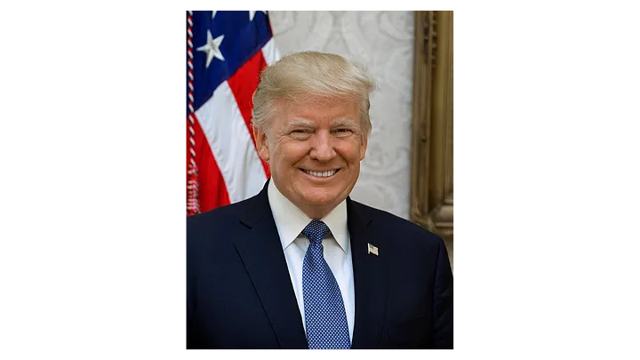 President Donald Trump in front of an American flag in 2017