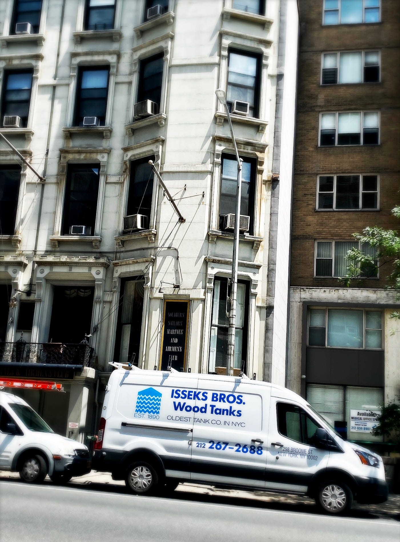 An Isseks Bros van in front of the now closed Soldiers', Sailors', Marines', Coast Guard and Airmens' Club.