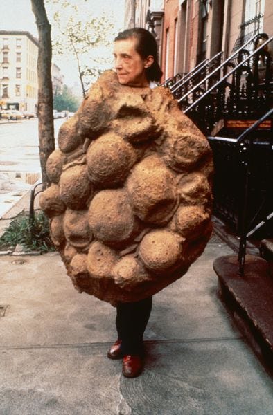 A photo of artist Louise Bourgeois dressed as a chocolate chip cookie
