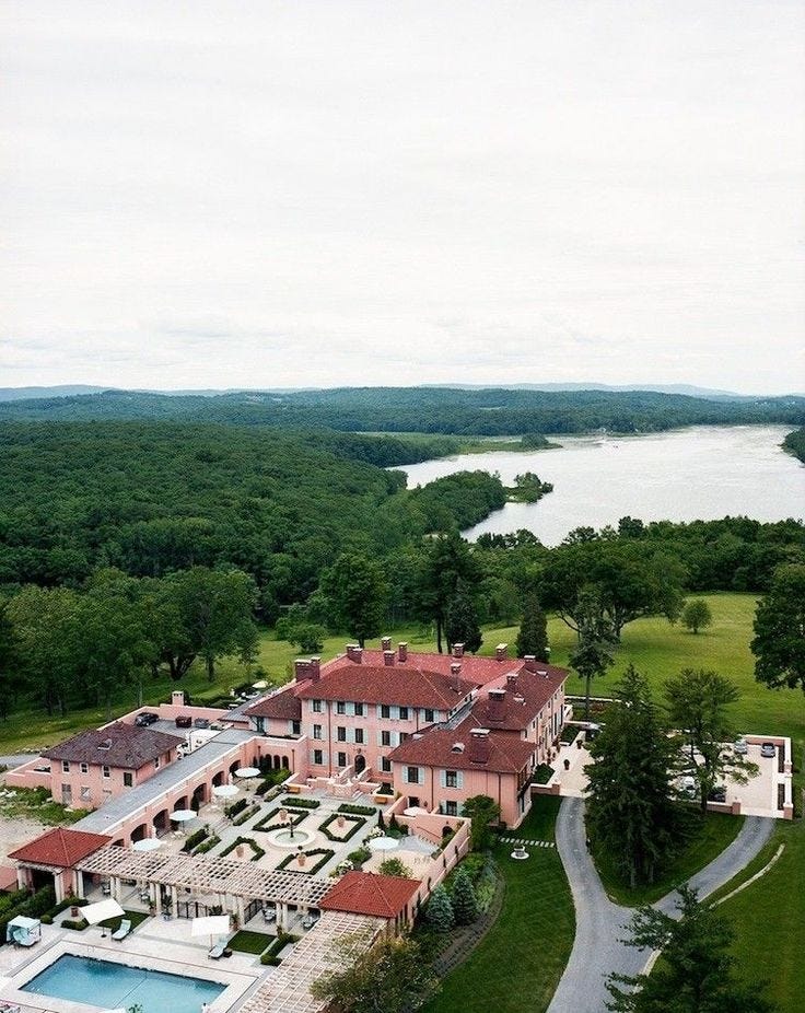This may contain: an aerial view of a large mansion with a pool in the foreground and trees surrounding it This may contain: an aerial view of a large mansion with a pool in the foreground and trees surrounding it