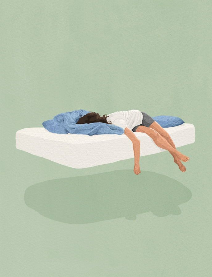 This may contain: a woman laying on top of a bed in the middle of green room with white walls