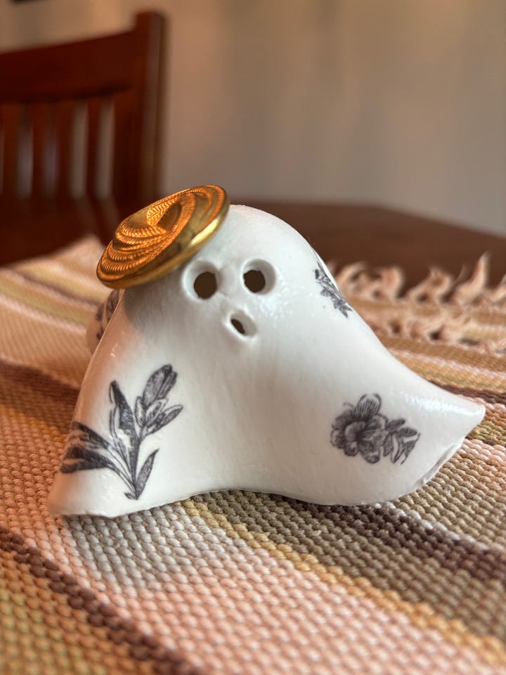 gallery of four clay ghosts decorated for Halloween