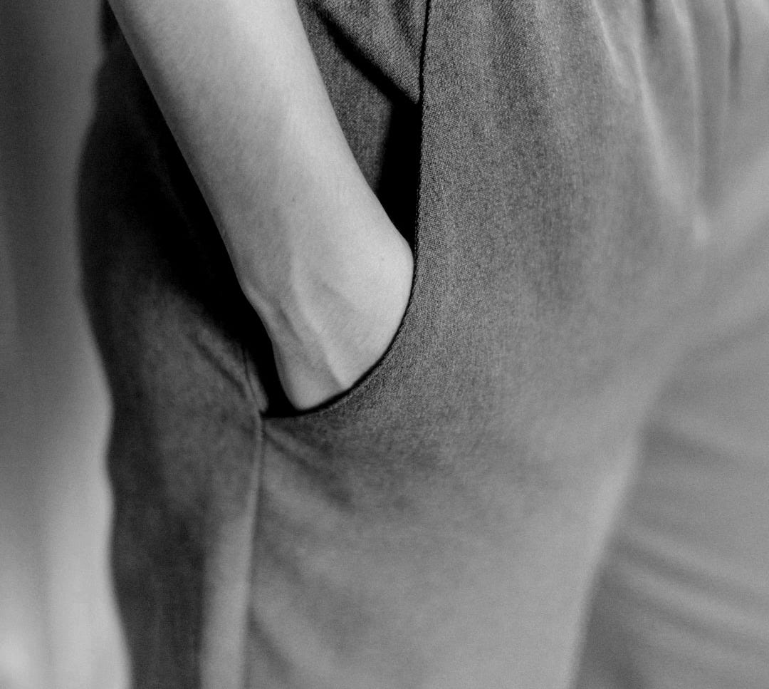 closeup photo of person hiding his right hand in his pocket