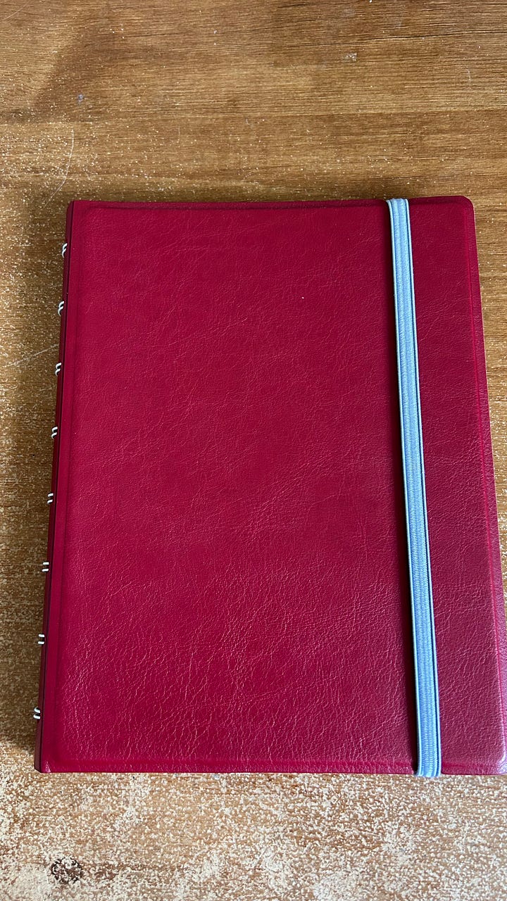 Filofax A5 refillable notebooks. One in red the other teal.