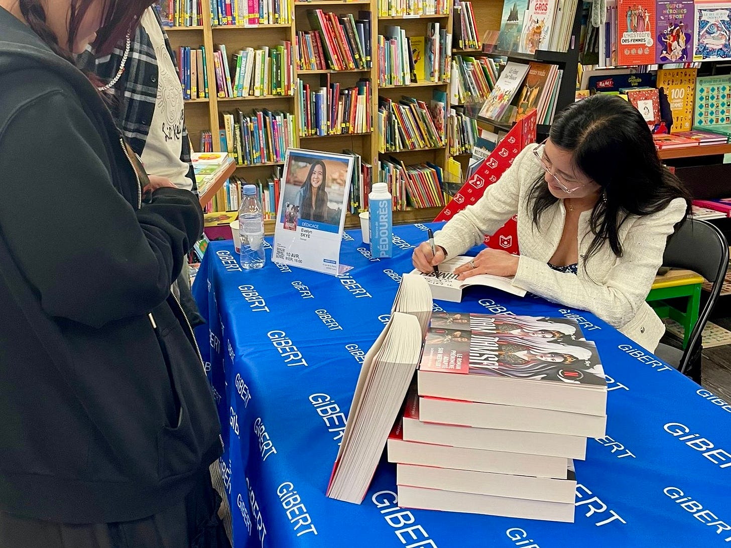 Author Evelyn Skye autographs books in Lyon, France