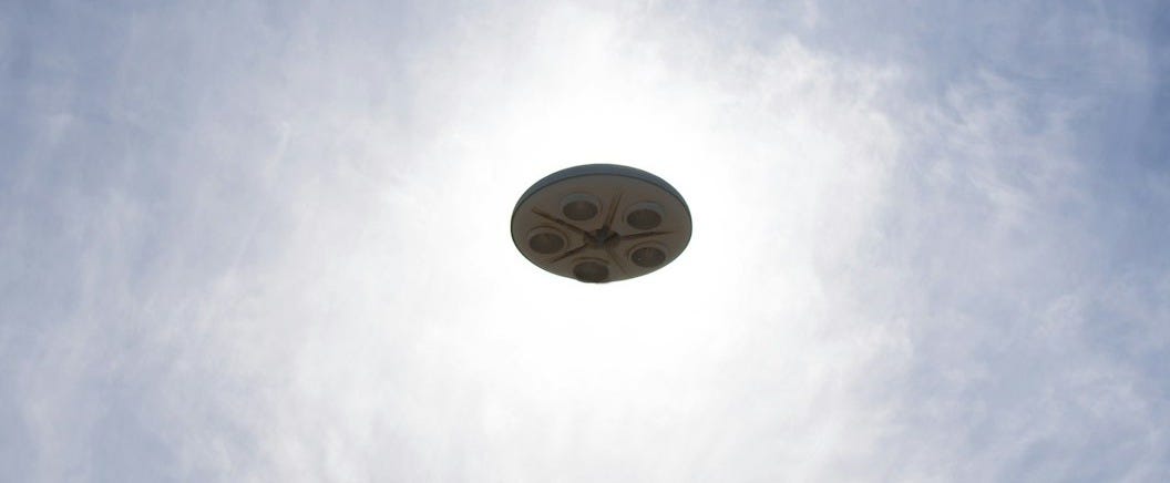 a frisbee flying through the air with a blue sky in the background a frisbee flying through the air with a blue sky in the background