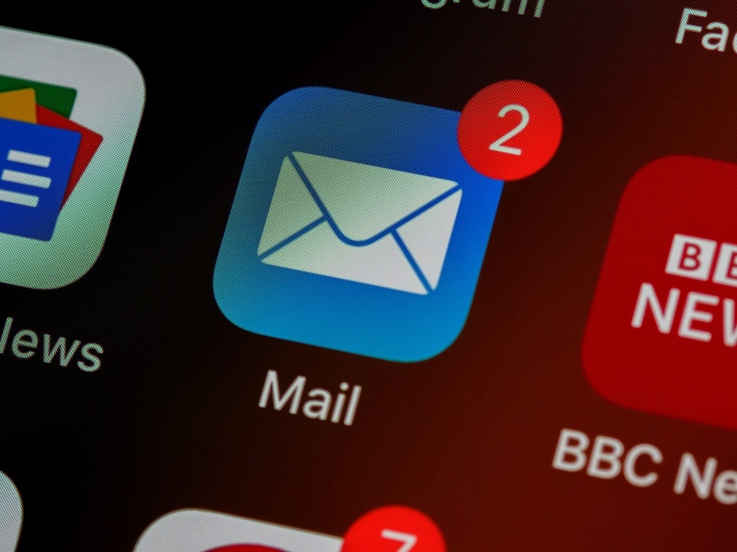 A photo of an email app icon showing two new emails. A photo of an email app icon showing two new emails.