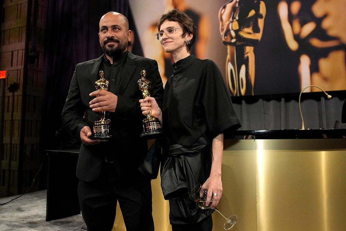 Hamdan Ballal, left, and Rachel Szor, winners of the award for best documentary feature film for "No Other Land," attend the Governors Ball after the Oscars in Los Angeles, March 2, 2025. (AP Photo/John Locher)