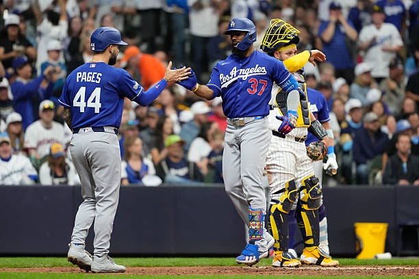 Teoscar Hernández of the Los Angeles Dodgers celebrates with Andy Pages after hitting a three-run home run to tie the game in the fourth inning...