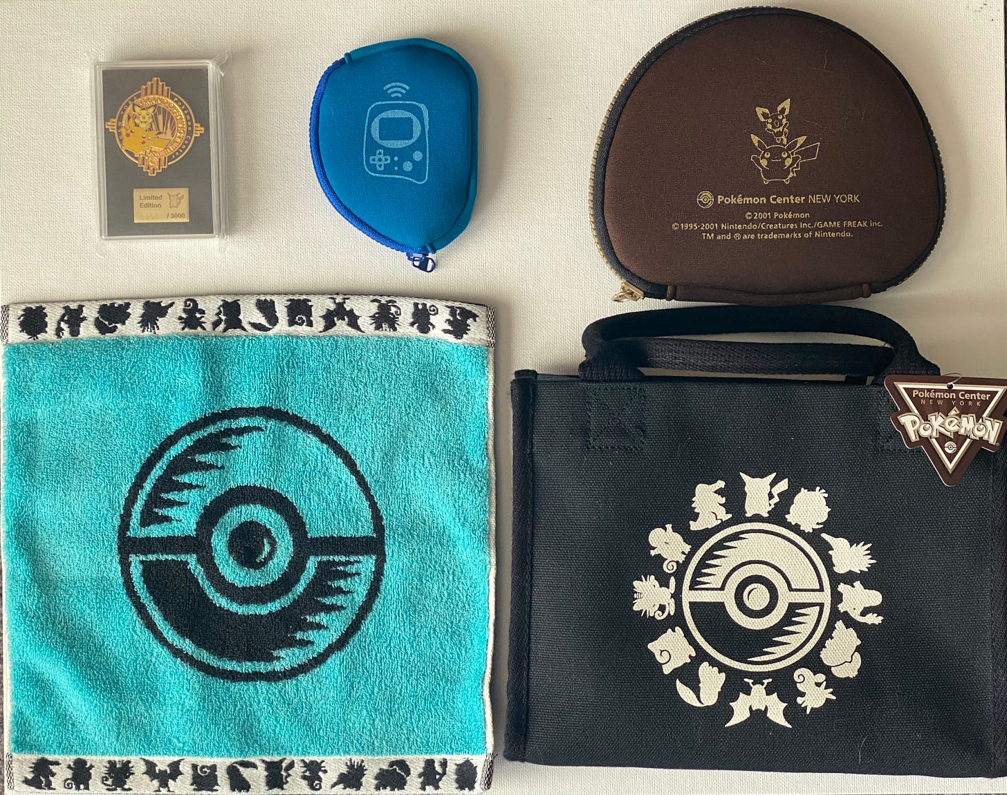Tatton shared some of the items he still owns from his visit to the Pokémon Center New York store, including a Grand Opening pin badge (0293/3000), Game Boy Advance and Pokémon Mini protective cases, a Poké Ball towel, and a bag which still has its original tag Tatton shared some of the items he still owns from his visit to the Pokémon Center New York store, including a Grand Opening pin badge (0293/3000), Game Boy Advance and Pokémon Mini protective cases, a Poké Ball towel, and a bag which still has its original tag