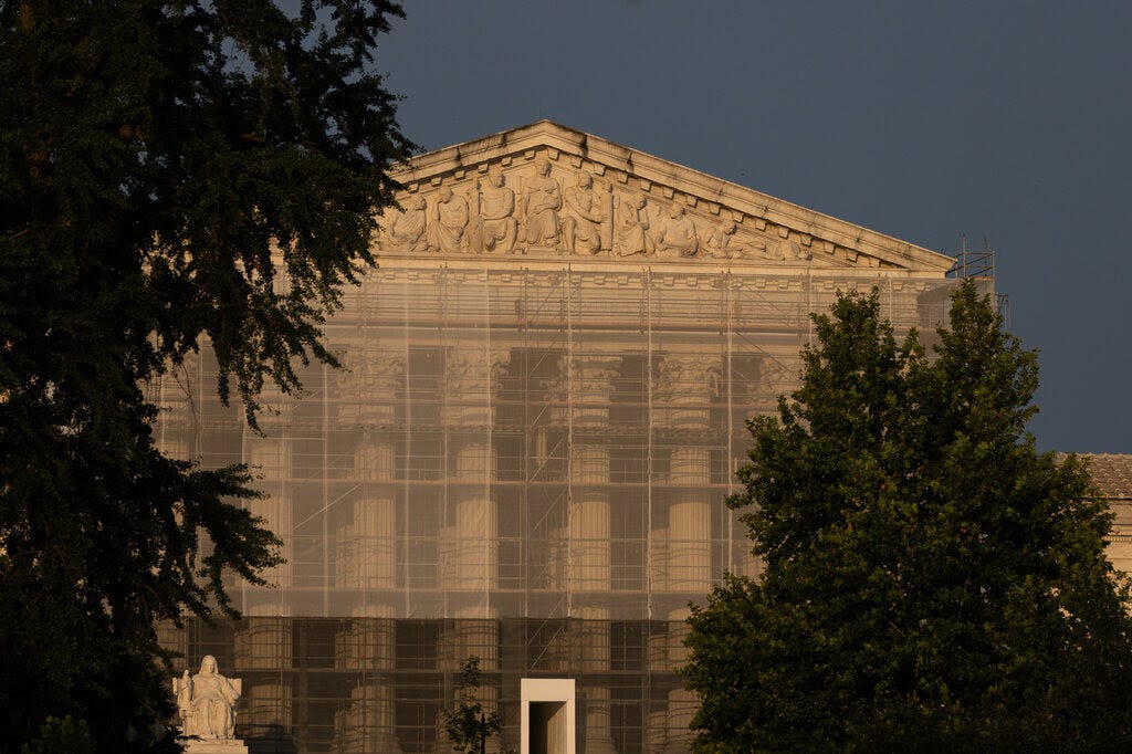 The U.S. Supreme Court at sunset with scaffolding out front.